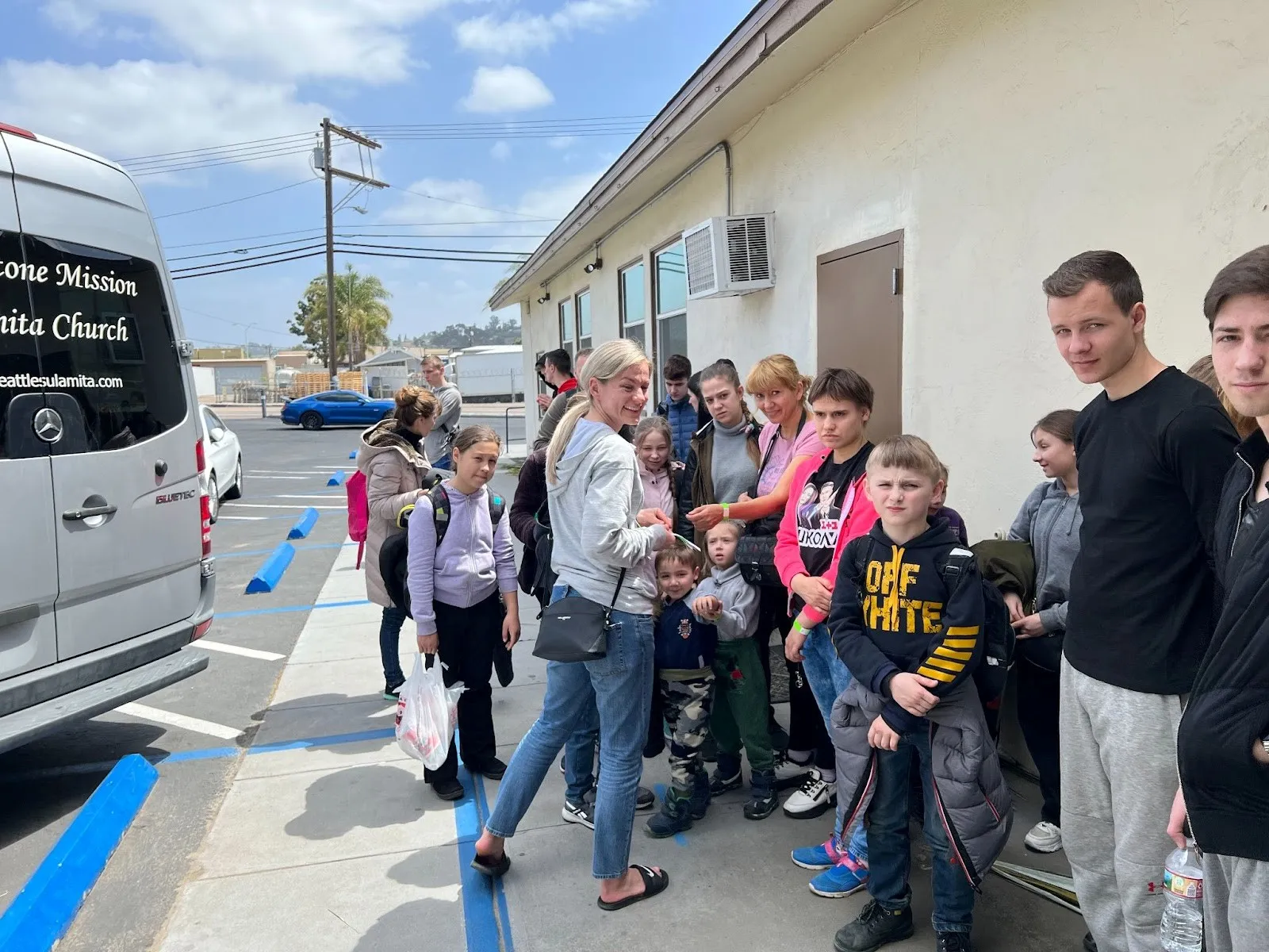 Olga coordinating transportation for refugees getting ready to depart from San Diego, CA.